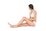 Side view of a fit young woman with knee pain
