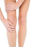 Close-up mid section of a young woman with knee pain