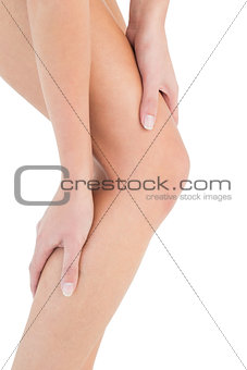 Close-up mid section of a fit woman with leg pain