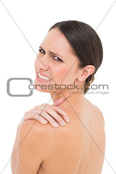 Close-up portrait of a topless woman with shoulder pain