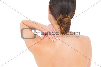 Close-up rear view of a topless woman with shoulder pain