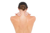 Close-up rear view of a topless woman with shoulder pain