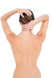 Rear view of a topless woman suffering from neck ache