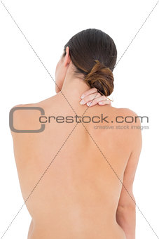 Rear view of a topless fit woman with shoulder pain
