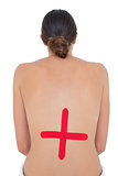 Topless fit woman with red cross sign on back