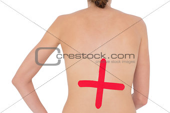Topless fit woman with red cross sign on back