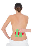 Topless fit woman with red and green strips on back
