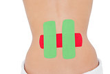Topless fit woman with red and green strips on back