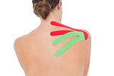 Topless woman with red and green strips on shoulder