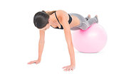 Fit woman doing push ups on fitness ball
