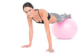 Fit woman doing push ups on fitness ball