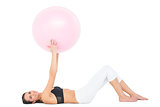 Portrait of a fit woman exercising with fitness ball