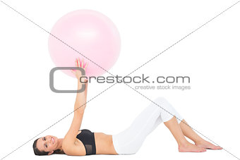 Portrait of a fit woman exercising with fitness ball