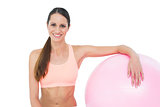 Portrait of a smiling fit woman with fitness ball