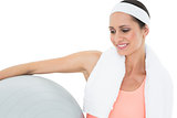 Close-up of a smiling fit woman holding fitness ball