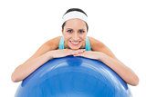 Portrait of a smiling fit woman with fitness ball