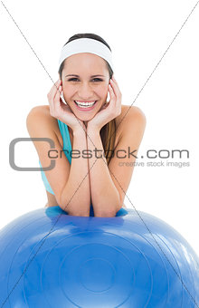 Happy fit young woman with fitness ball