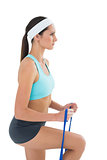 Fit young woman exercising with a blue yoga belt