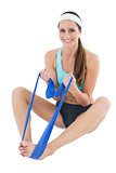 Smiling fit woman exercising with a blue yoga belt