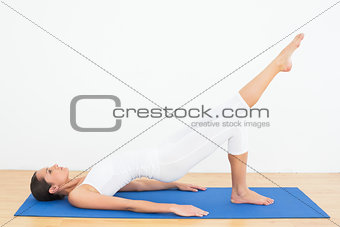Fit woman doing pilate exercises in the fitness studio