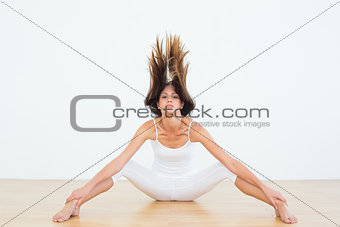 Toned woman tossing hair in fitness studio