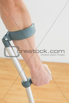 Close-up of a mans hand with crutch