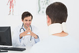 Doctor in conversation with patient at office desk