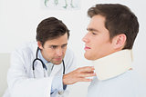 Doctor examining a patients sprained neck