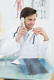 Doctor using telephone at the medical office