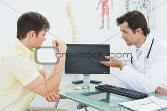 Doctor in conversation with patient at medical office