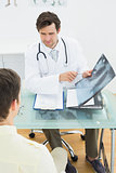 Doctor explaining x-ray reports to patient in office