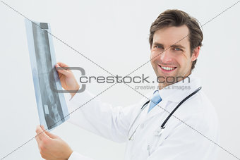 Side view portrait of a male doctor examining spine x-ray