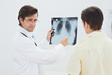 Portrait of a doctor explaining lungs x-ray to patient