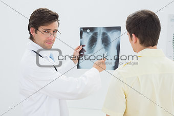 Portrait of a doctor explaining lungs x-ray to patient