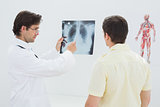 Male doctor explaining lungs x-ray to patient