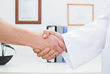 Close-up of a doctor and patient shaking hands