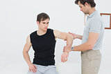 Male physiotherapist examining a mans hand