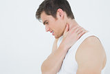 Close-up side view of a man suffering from neck pain