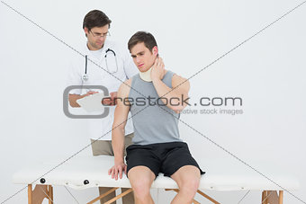 Male doctor listening to patient with concentration