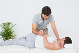Male physiotherapist examining patient