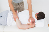 Male physiotherapist massaging patient