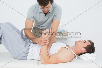 Male doctor examining a patients hand