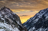 Winter mountains at sunset with colorful clouds and sky