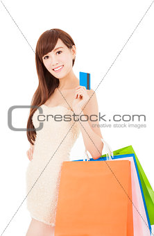 Young woman holding group shopping bag and credit card 