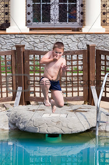 Boy jumps in the pool
