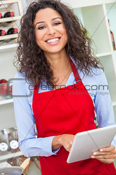 Woman Using Tablet Computer Cooking in Kitchen