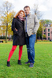 Outdoor happy couple in love, Museum Plein, autumn Amsterdam bac