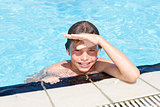 Activities on the pool. Cute boy swimming and playing in water i