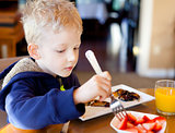child eating breakfast