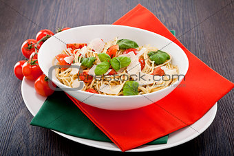fresh tasty pasta spaghetti with tomatoes and basil